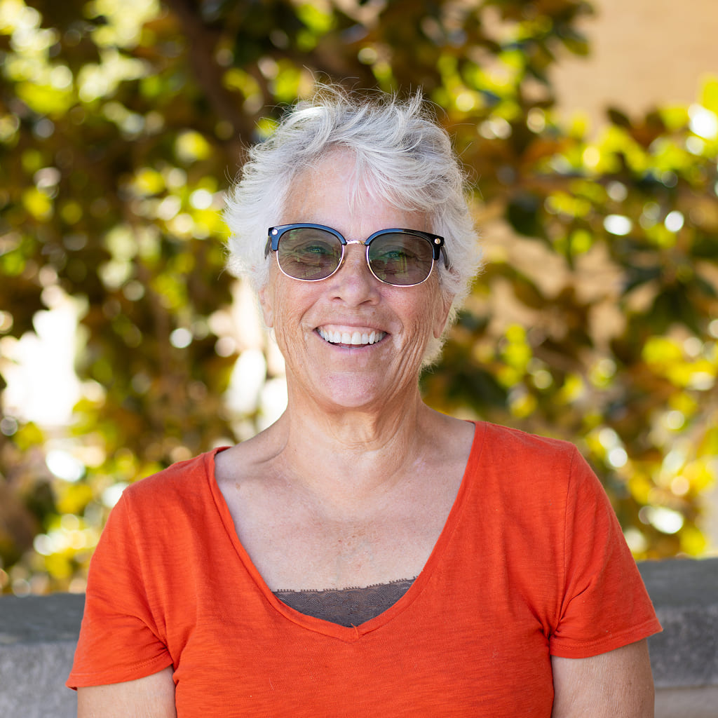 Smiling woman in red t-shirt and glasses